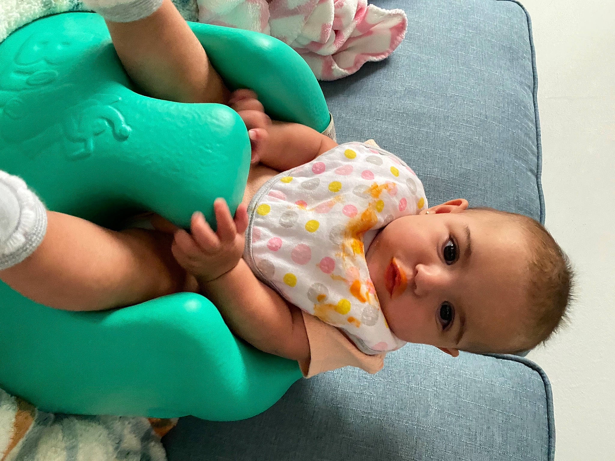 Roselynn is registered to the contest to win money with this photo: arm, baby, baby_products, baby_toddler_clothing, blue, child, comfort, facial_expression, finger, green, hand, human_body, joint, knee, linens, person, product, skin, textile, thigh