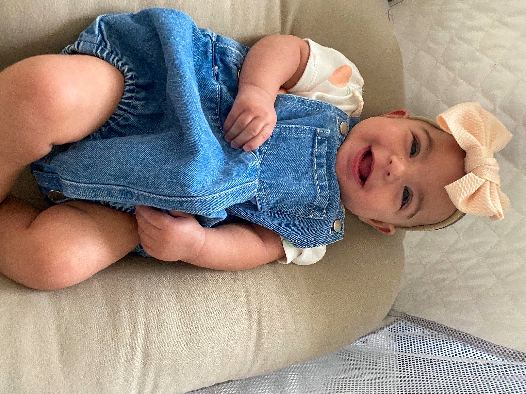 Roselynn is registered to the contest to win money with this photo: arm, baby, baby_sleeping, baby_toddler_clothing, comfort, finger, glasses, hand, headwear, human_body, joint, knee, leg, mouth, person, skin, sleeve, smile, stomach, textile