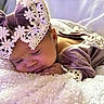 Kailani is registered to the contest to win money with this photo: baby, sleeping, purple_outfit, lace, bow, blanket, soft_texture, closeup, infant, peaceful, cute, resting, portrait, indoor, newborn, child, headwear, delicate, cozy, soft_lighting
