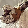 Kailani is registered to the contest to win money with this photo: baby, sleeping, bow, headwear, blanket, soft, cozy, infant, closeup, face, child, cute, resting, textile, fabric, comfort, portrait, indoor, peaceful, adorable