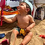 Lyam participe au concours pour gagner de l'argent avec cette photo : toddler, beach, sand, toy, shovel, dinosaur_toy, cap, swim_shorts, sunny, outdoor, child, play, summer, vacation, happy, barefoot, sitting, sunlight, umbrella, relaxation