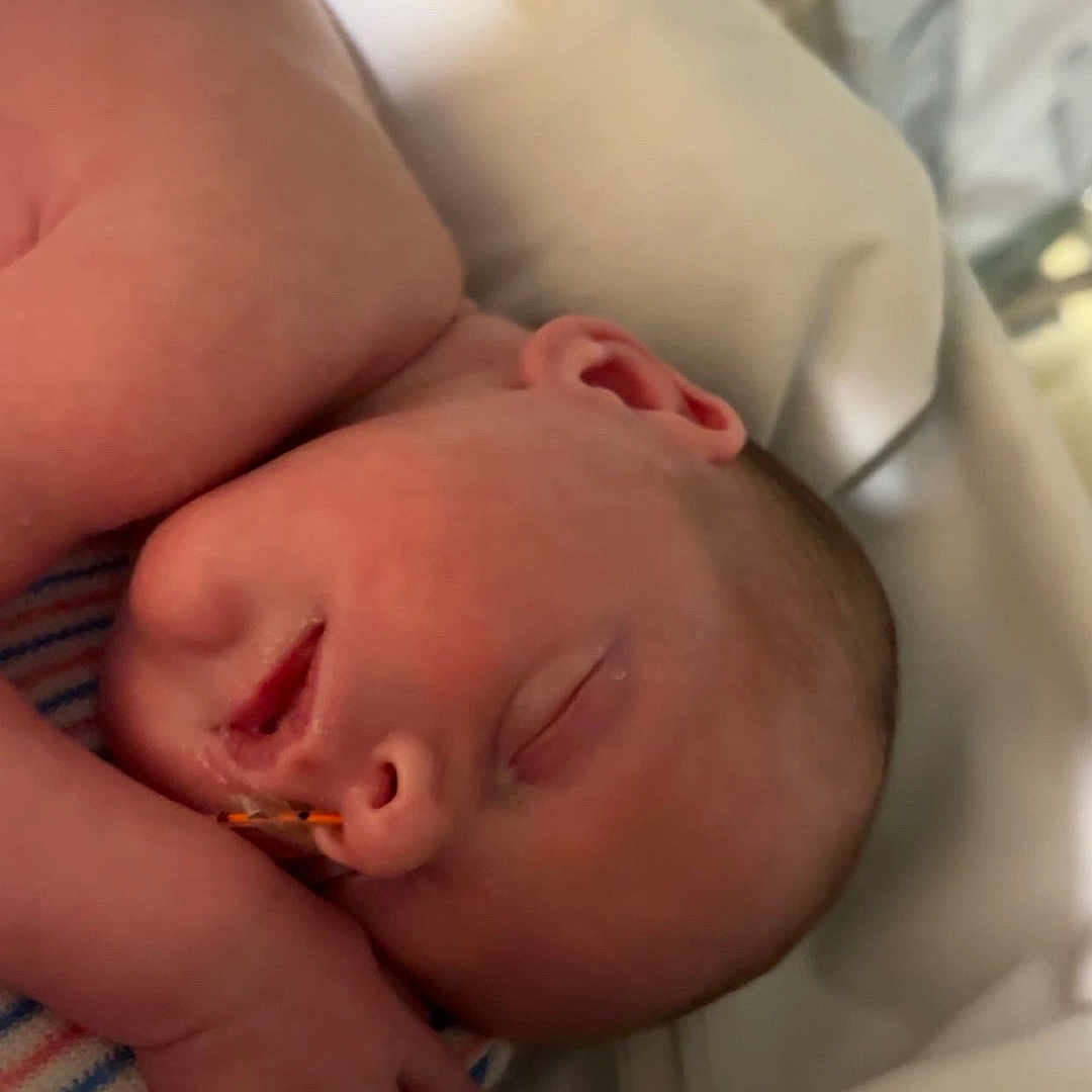 Stanlee joined the competition — help win amazing prizes! newborn, baby, sleeping, hospital, bassinet, blanket, nasal_tube, infant, patient, healthcare, medical, bed, peaceful, closeup, skin, head, face, resting, child, indoor