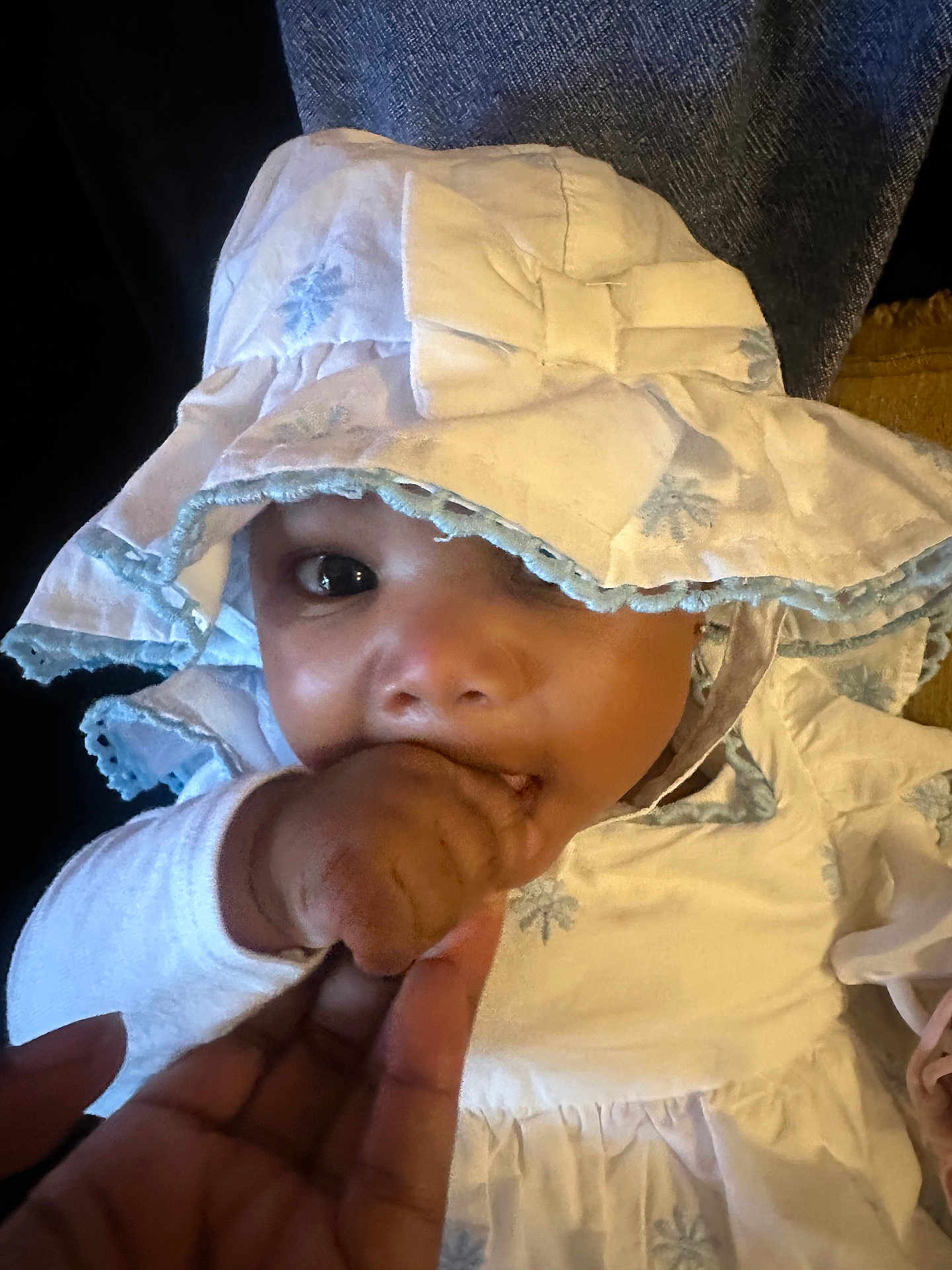 Ember joined the competition — help win amazing prizes! baby, child, face, hand, fingers, clothing, bonnet, white, blue, embroidery, cute, infant, portrait, closeup, soft, fabric, indoor, person, skin, support