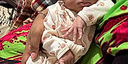 Ember joined the competition — help win amazing prizes! baby, blanket, child, closeup, cradle, cute, fabric, flower, hand, headband, indoor, infant, newborn, onesie, pacifier, patterned_clothing, person, plaid, sleepy, soft