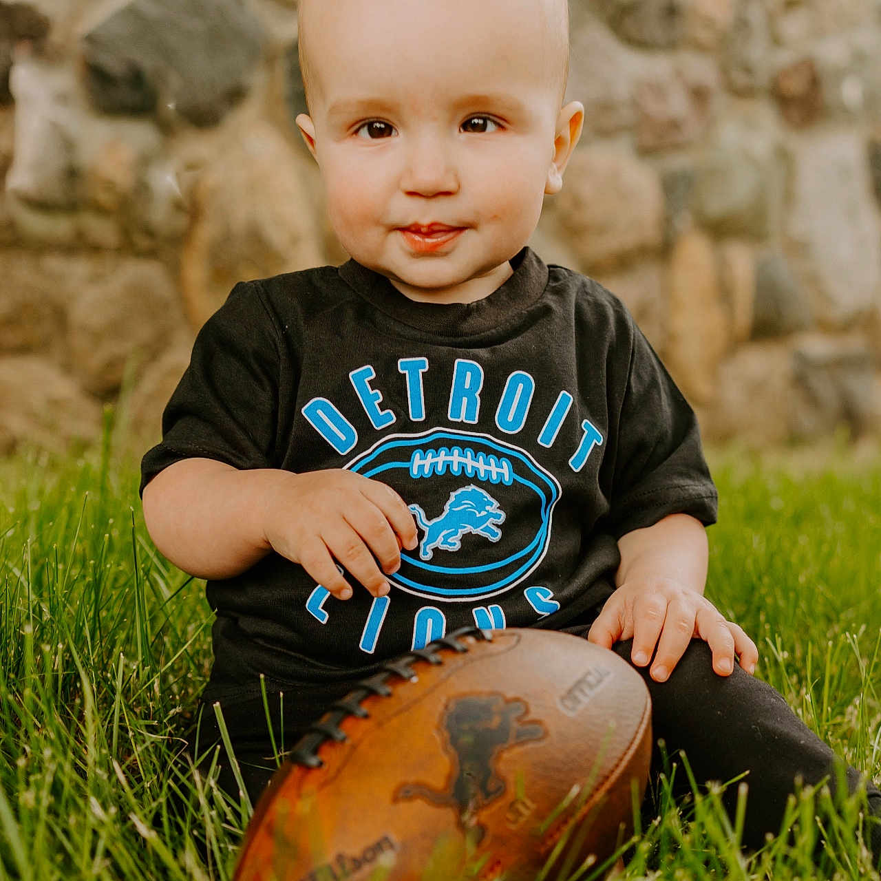 Carson joined the competition — help win amazing prizes! baby, ball, clothing, face, football, grass, head, people, person, photography, plant, portrait, rock, rugby, rugbyball, sitting, soccer, soccerball, sport, t_shirt