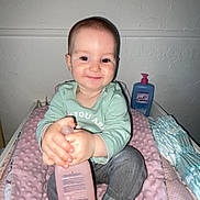 Hailee participe au concours pour gagner de l'argent avec cette photo : baby, baby_clothes, bottle, child, cute, diapers, foot, hand, happy, indoor, infant, lotion, person, pink_blanket, portrait, sitting, skin_care, smiling, texture, wall