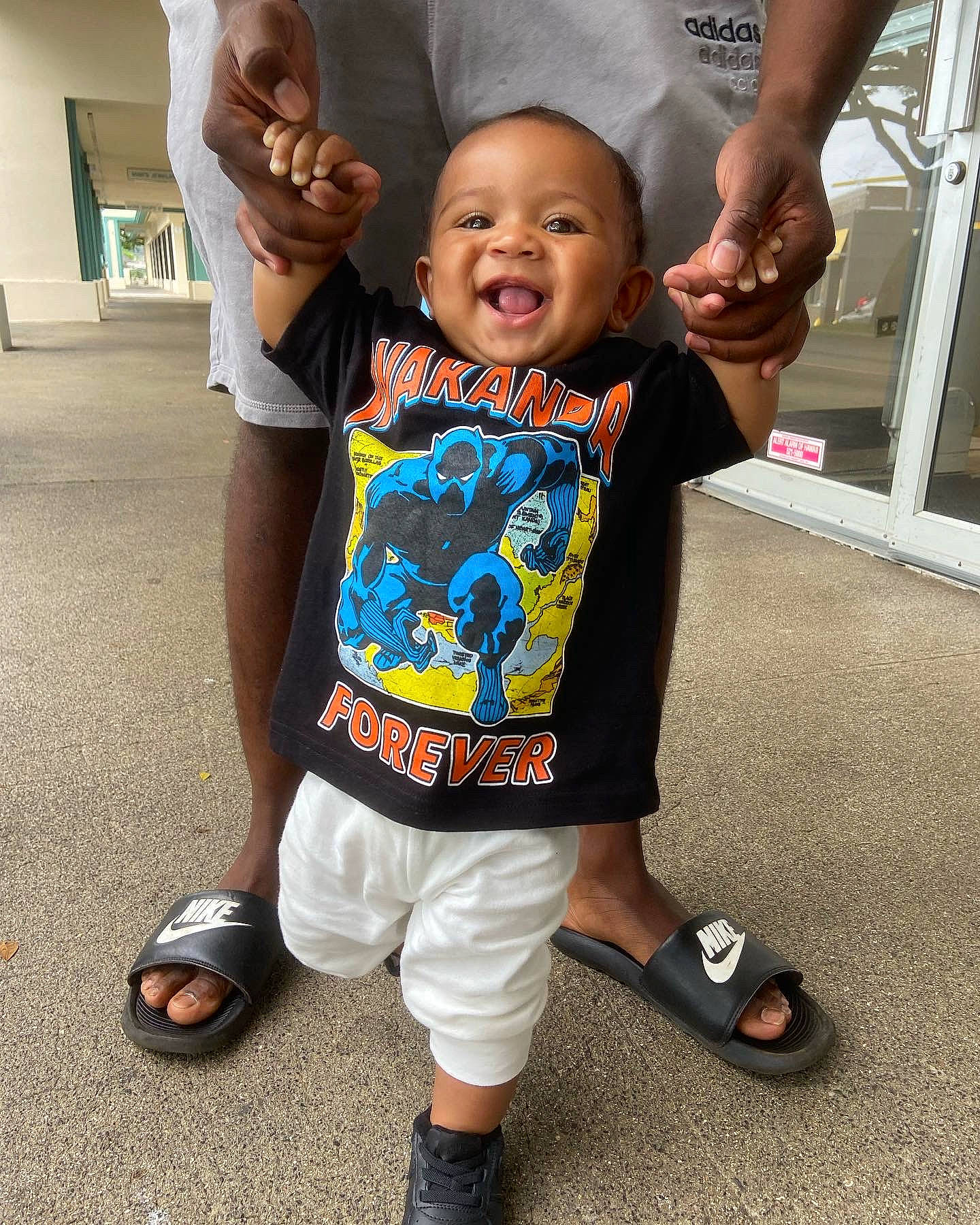 Nohili is registered to the contest to win money with this photo: baby, baby_toddler_clothing, child, event, footwear, fun, gesture, happy, leg, leisure, people, person, product, sandal, shoe, sleeve, smile, sneakers, sportswear, t_shirt