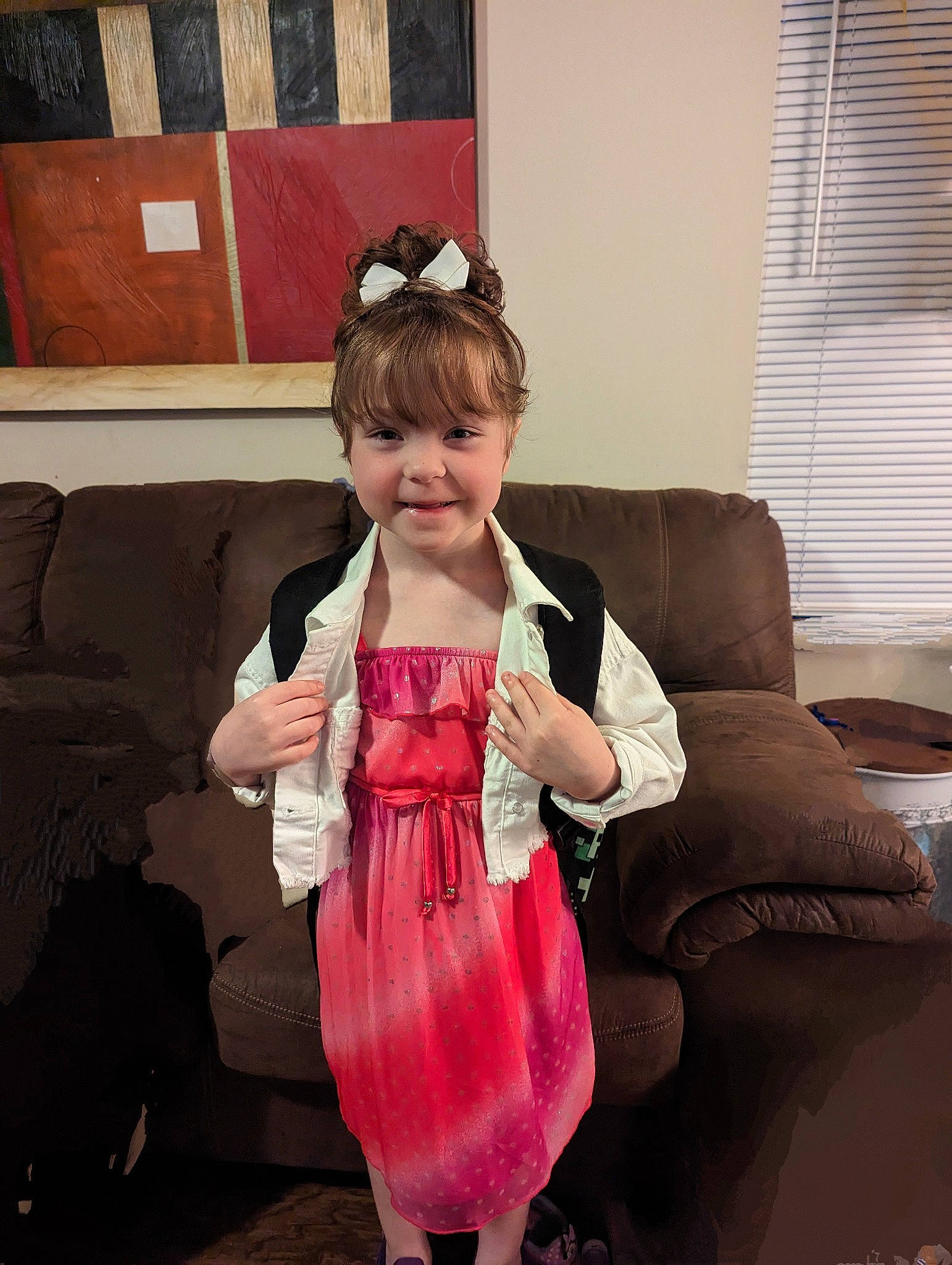 Gracie joined the competition — help win amazing prizes! automotive_tire, baby_toddler_clothing, couch, dress, event, flooring, fun, happy, joy, magenta, person, room, sitting, sleeve, smile, sunglasses, tire, toddler, wheel, window_blind