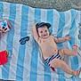 baby, towel, beach, sunglasses, bucket, sunscreen, stones, number_5, striped_diaper, cap, floaties, mickey_mouse, sand, smiling, child, sun_protection, outdoor, play, relaxing, summer