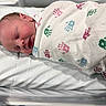 newborn, baby, infant, sleeping, sleepy, face, portrait, swaddled, blanket, hospital, bed, bedding, indoors, peaceful, resting, closed_eyes, head, skin, patterned_blanket, photograph