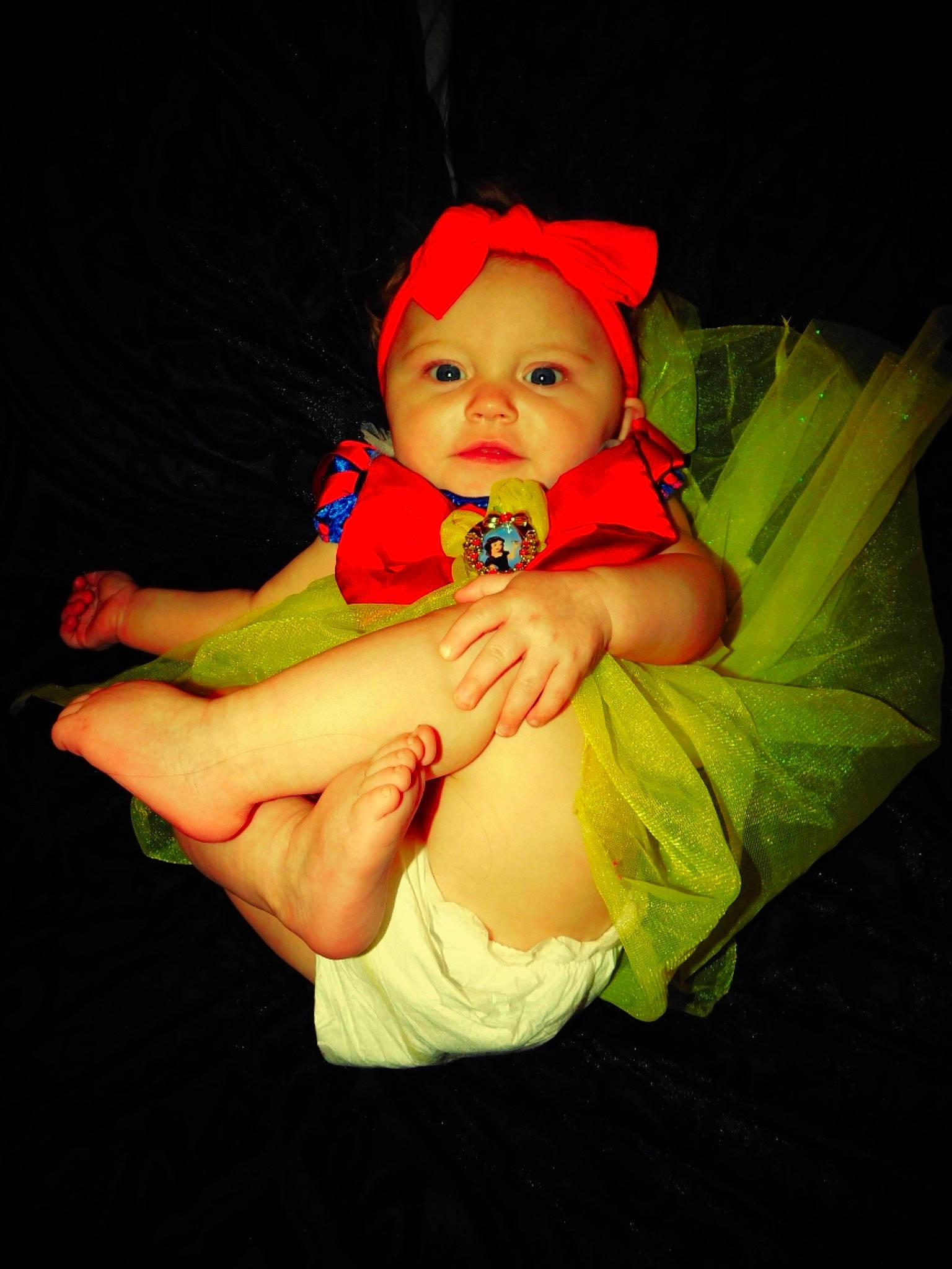 Haylie is registered to the contest to win money with this photo: arm, baby, baby_products, child, costume, ear, eye, fun, hand, headwear, human_body, orange, person, photography, product, red, smile, toddler, yellow