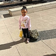 Bella joined the competition — help win amazing prizes! child, girl, unicorn_sweater, bag_of_popcorn, boots, sidewalk, shadow, park, tree, bench, stone_sculpture, outdoor, daylight, smile, standing, concrete, casual_clothing, portrait, happy, cute