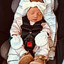 baby, infant, sleeping, car_seat, headband, bow, mittens, blanket, clothing, footwear, shoes, safety_harness, cute, child, newborn, portrait, indoors, resting, peaceful, pink
