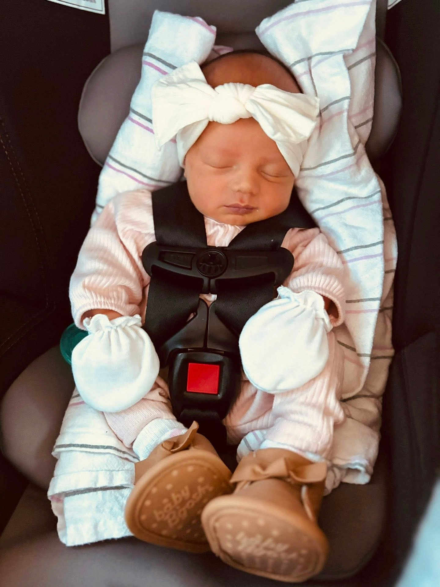 Elizah joined the competition — help win amazing prizes! baby, infant, sleeping, car_seat, headband, bow, mittens, blanket, clothing, footwear, shoes, safety_harness, cute, child, newborn, portrait, indoors, resting, peaceful, pink