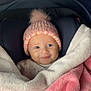 Joy participe au concours pour gagner de l'argent avec cette photo : baby, blanket, car_seat, hat, knitted_hat, pom_pom, smile, child, infant, cozy, warm, pink, white, clothing, face, portrait, cute, soft, indoor, comfort