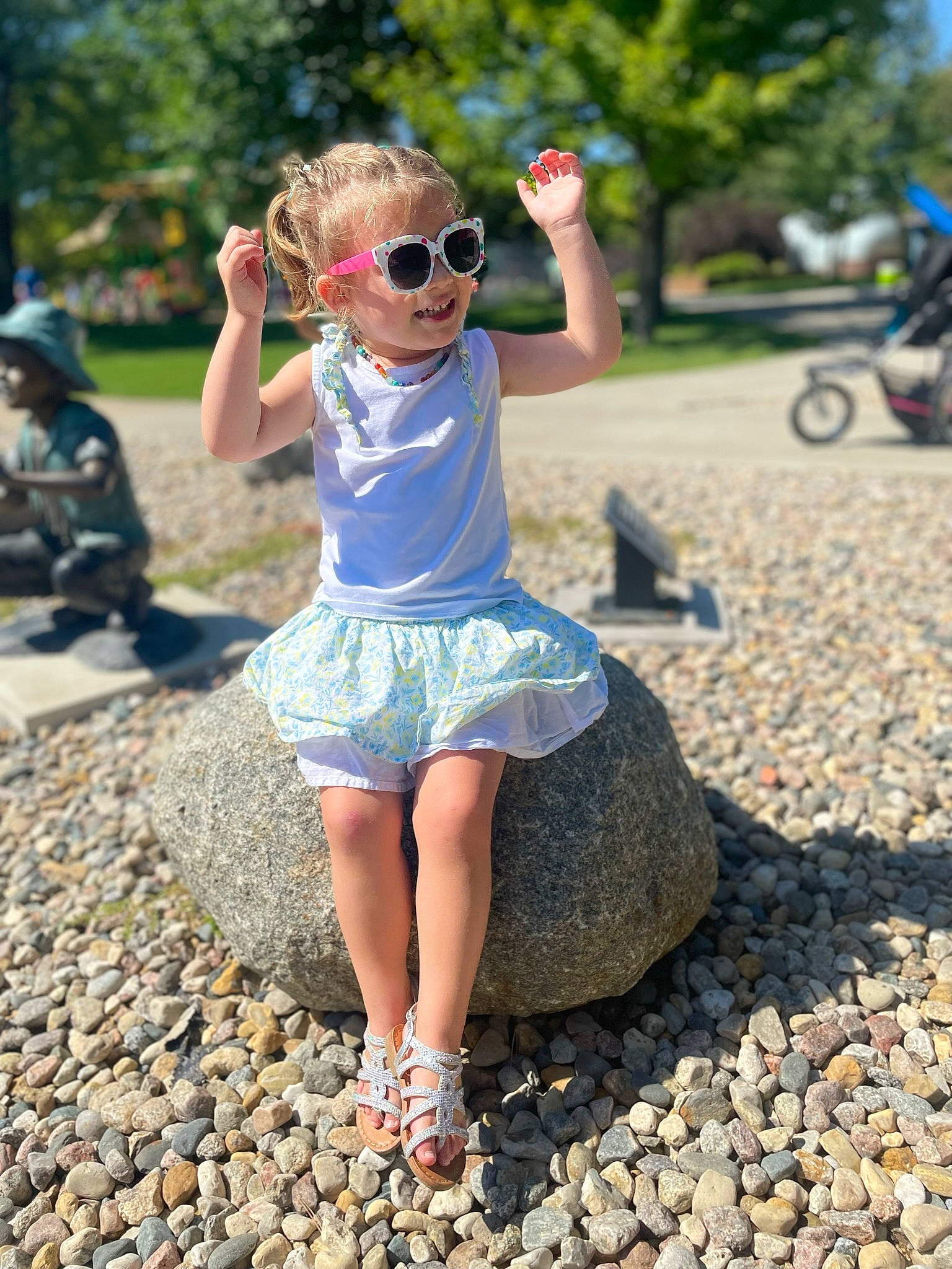 Sawyer is registered to the contest to win money with this photo: asphalt, child, denim, electric_blue, eyewear, fun, grass, happy, human_leg, landscape, leaf, leisure, people_in_nature, person, plant, recreation, road_surface, sunglasses, toddler, tree