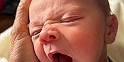 Klark Kent Thomas is registered to the contest to win money with this photo: baby, newborn, yawn, mouth_open, hand, holding, onesie, close_up, face, portrait, sleepy, infant, skin, nose, ear, eyelashes, blanket, indoor, soft_light, caregiver_hand