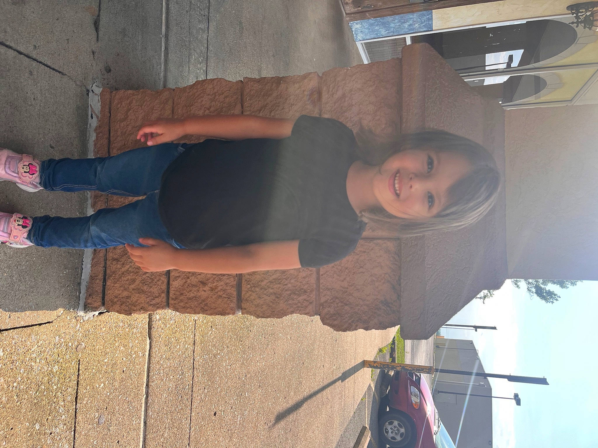 Valerie is registered to the contest to win money with this photo: concrete, cool, denim, elbow, electric_blue, eyewear, fun, human_leg, joy, knee, pattern, person, shadow, sidewalk, sitting, smile, sportswear, t_shirt, thigh, tints_and_shades