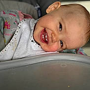 Maddy participe au concours pour gagner de l'argent avec cette photo : baby, child, smile, high_chair, bib, teeth, face, happy, infant, clothing, seat, unicorn, princess, pink, closeup, portrait, head_tilt, cute, indoor, person