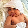 baby, towel, hood, smile, tongue, blanket, skin, cheek, arm, cute, infant, child, face, eyes, soft, cozy, indoors, happy, portrait, person