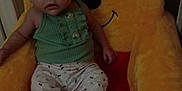 Kai joined the competition — help win amazing prizes! baby, child, plush_chair, winnie_the_pooh, indoor, carpet, green_top, patterned_pants, seated, cute, face, expression, toy, soft, childhood, comfort, person, small, furniture, cozy
