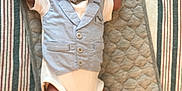 Legend joined the competition — help win amazing prizes! baby, infant, newborn, vest, bow_tie, quilted_mat, striped_blanket, baby_wipes, lying_down, arms_up, curious_expression, soft_lighting, indoors, clothing, cute, small, person, child, face, head