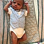 baby, infant, newborn, vest, bow_tie, quilted_mat, striped_blanket, baby_wipes, lying_down, arms_up, curious_expression, soft_lighting, indoors, clothing, cute, small, person, child, face, head