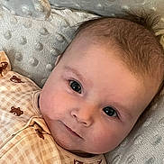 Calleigh is registered to the contest to win money with this photo: baby, infant, face, eyes, smile, clothing, bear_pattern, blanket, texture, soft_light, closeup, cute, portrait, child, newborn, skin, head, lying_down, cozy, indoors