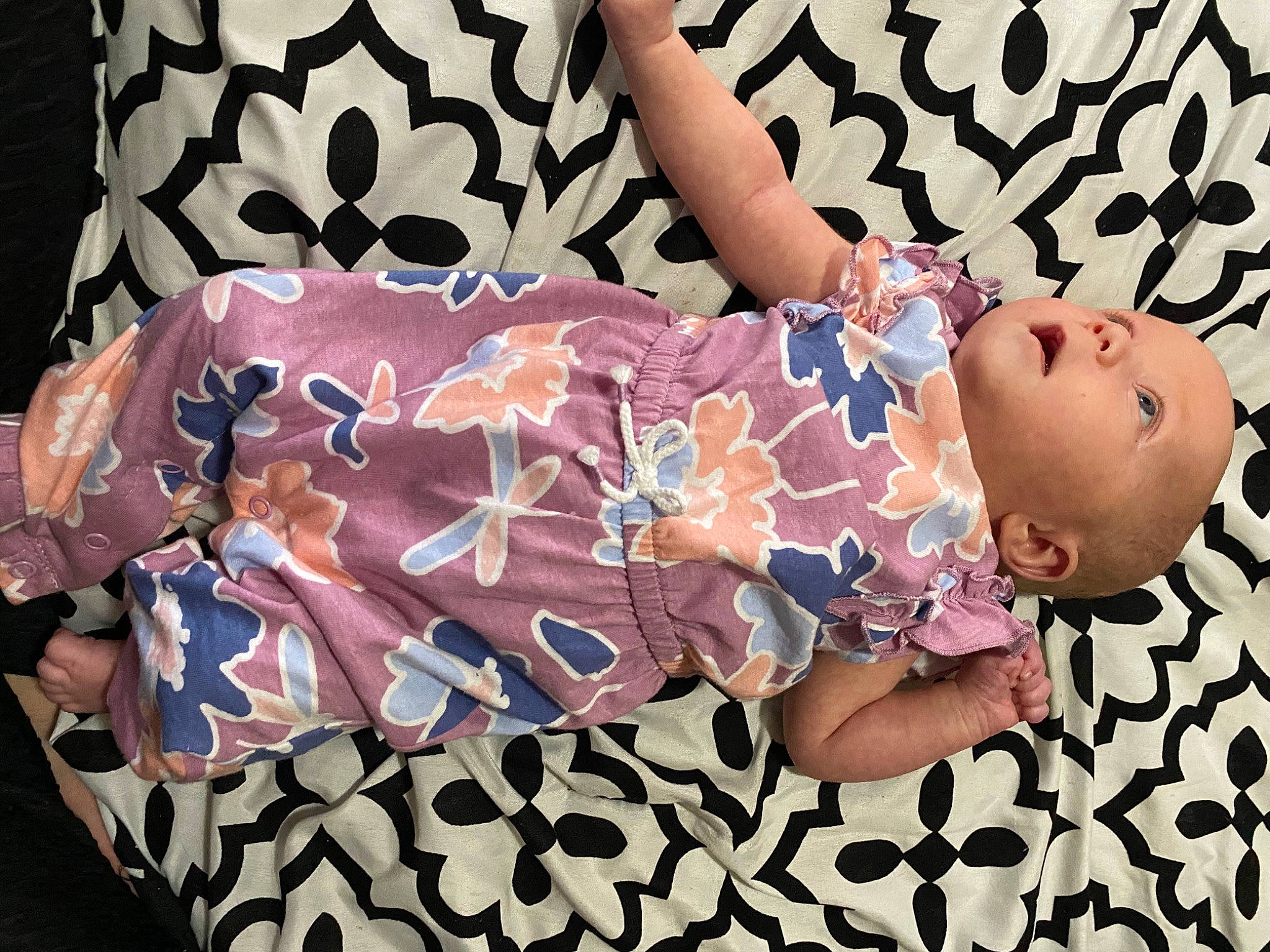 Lillith is registered to the contest to win money with this photo: baby, baby_products, baby_sleeping, baby_toddler_clothing, child, comfort, day_dress, fashion_accessory, font, hand, human_body, leg, linens, pattern, person, pink, purple, sitting, sleeve, thigh