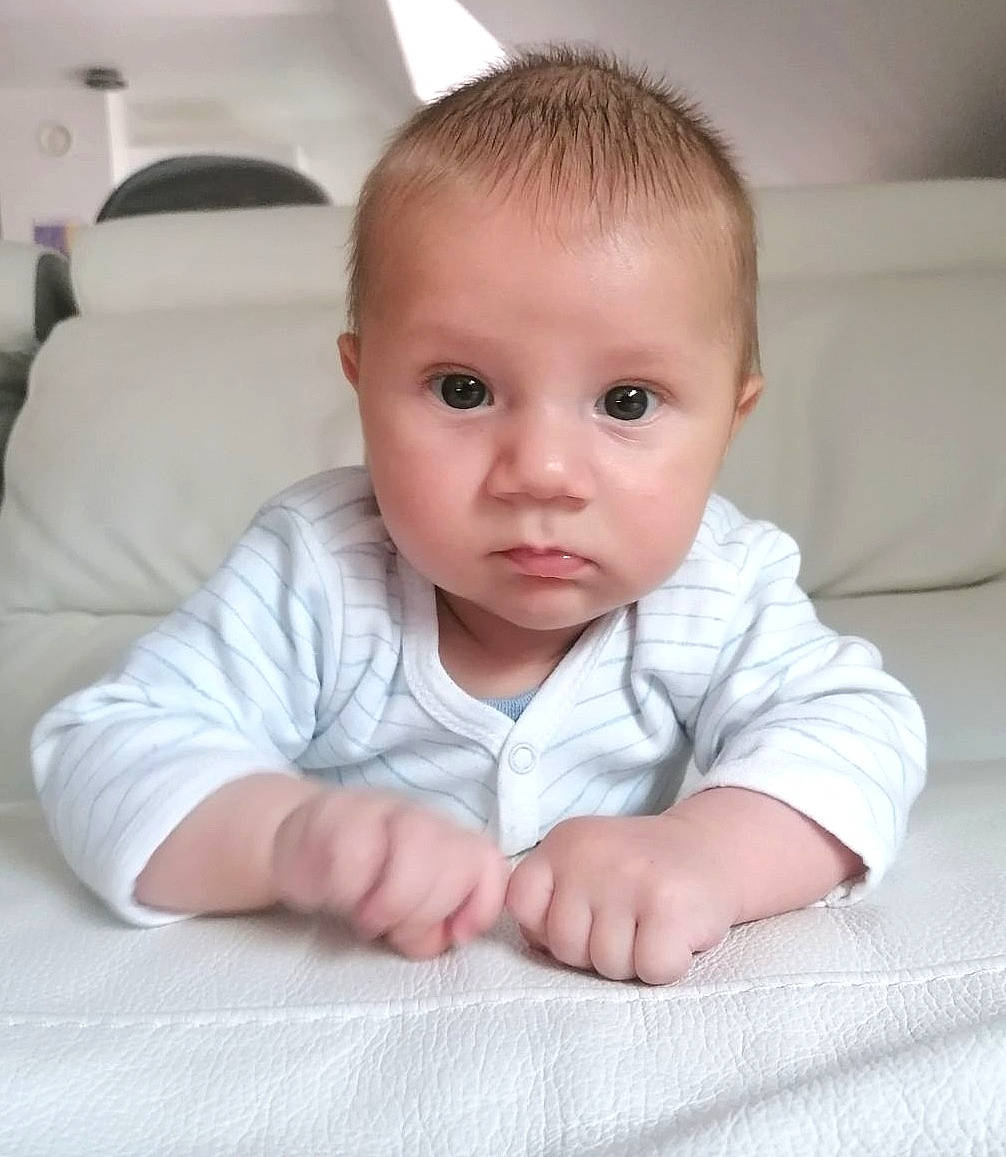 Lucas participe au concours pour gagner de l'argent avec cette photo : baby, baby_toddler_clothing, cheek, child, chin, comfort, eye, eyelash, flooring, hair, head, iris, linens, no_expression, nose, person, sitting, skin, sleeve, smile