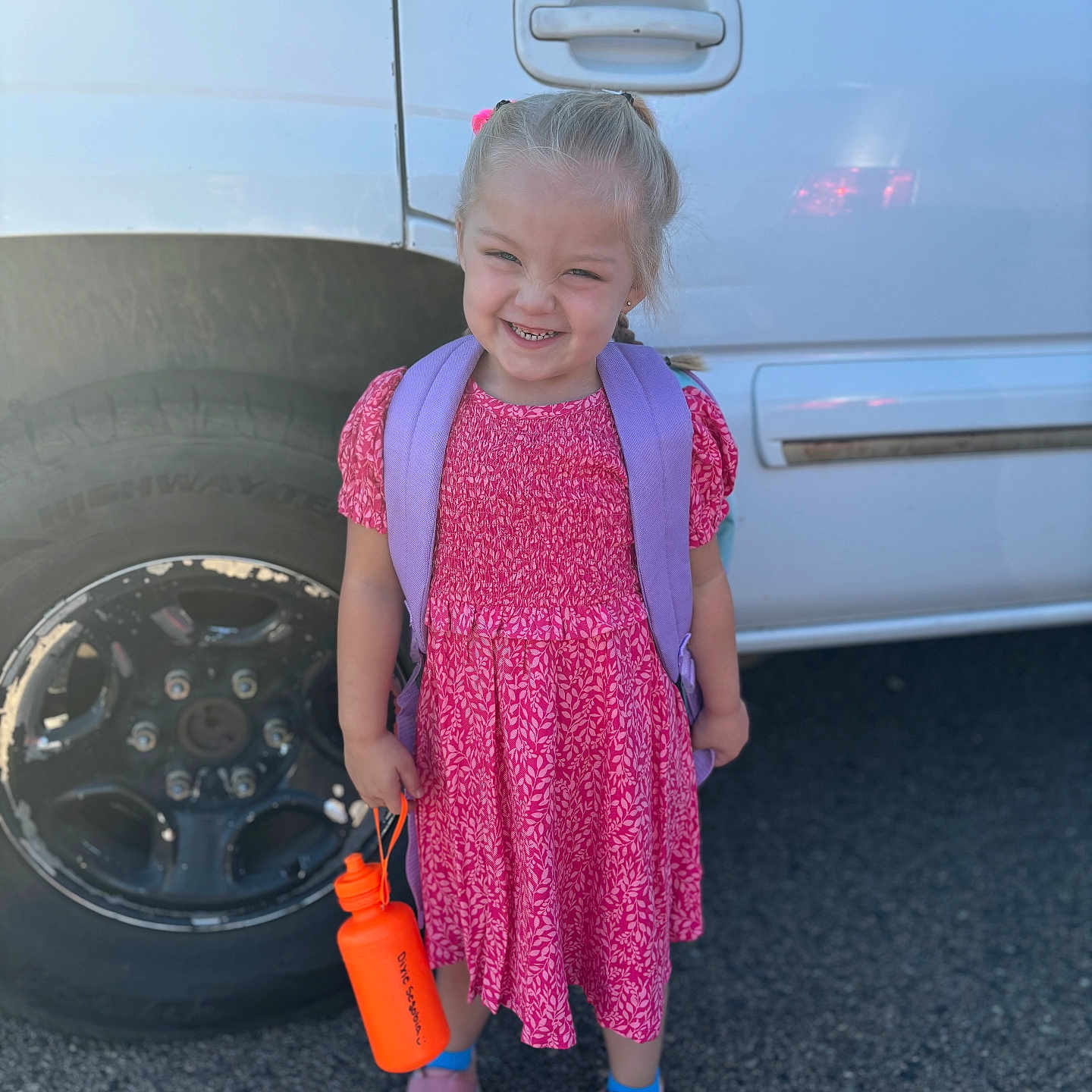 Dixie is registered to the contest to win money with this photo: alloywheel, car, carwheel, child, clothing, dress, face, female, footwear, girl, head, machine, person, photography, shoe, spoke, tire, transportation, vehicle, wheel
