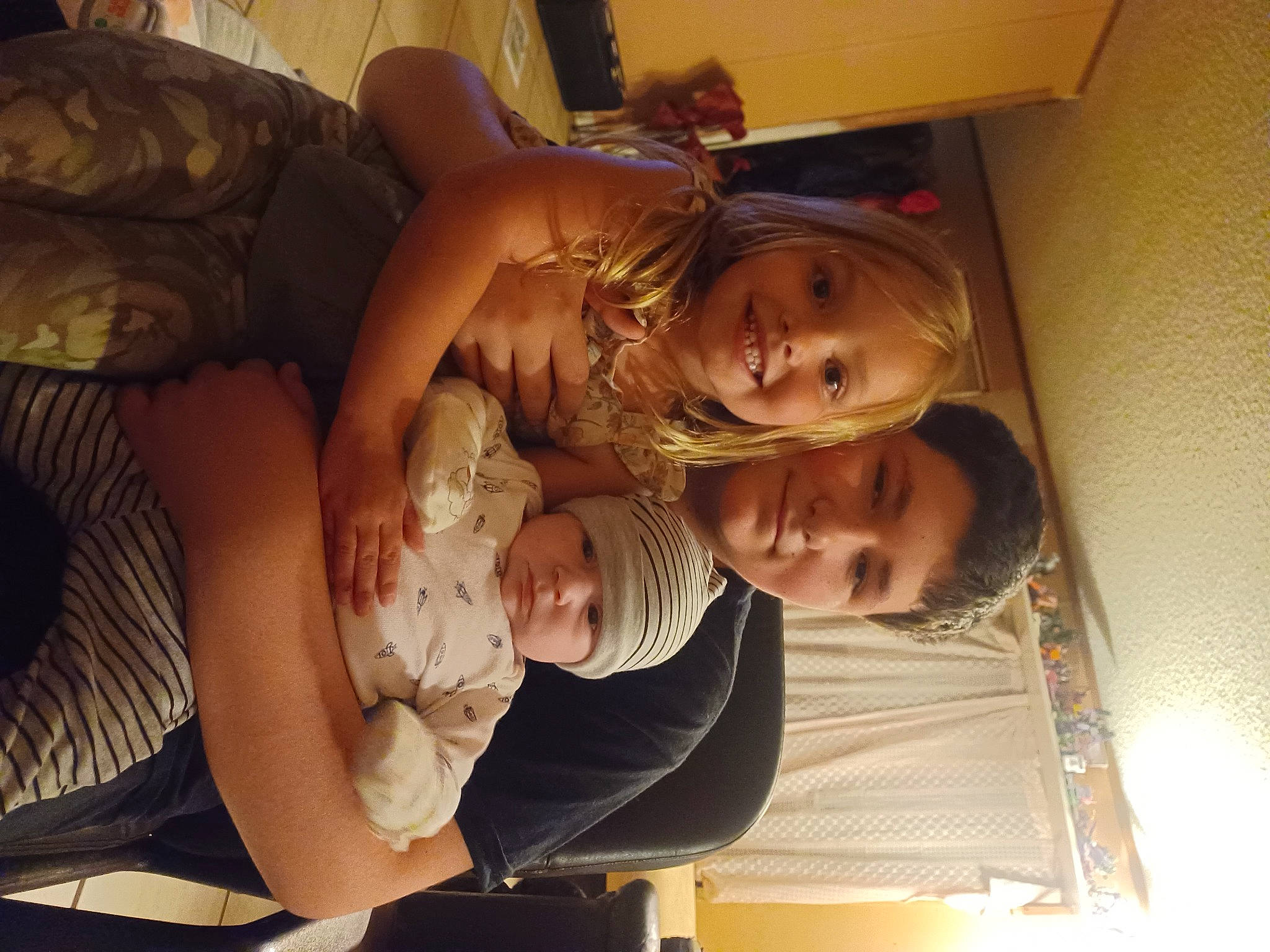 Azariah joined the competition — help win amazing prizes! abdomen, arm, baby, chest, child, comfort, fun, happy, headwear, joy, lap, person, room, sitting, smile, thigh, toddler, tree, trunk, wood