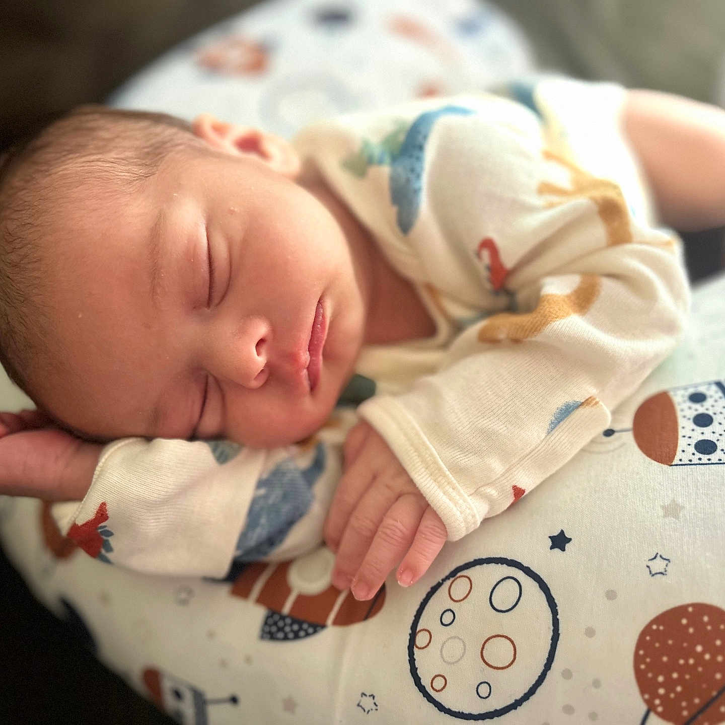 Chris is registered to the contest to win money with this photo: baby, child, clothing, crown, cute, face, hand, indoors, infant, newborn, peaceful, pillow, planets, portrait, rest, sleeping, soft, space_theme, stars, young