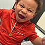child, toddler, smiling, curly_hair, orange_shirt, gold_necklace, happy, indoor, portrait, cute, person, laughing, casual_clothing, young, face, human, joy, emotion, closeup, seated