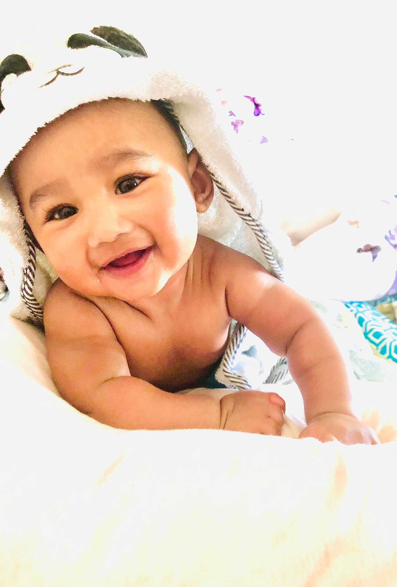 Omar joined the competition — help win amazing prizes! baby, smiling, towel, panda, cute, infant, child, happy, portrait, skin, blanket, face, eyes, mouth, drool, arm, hand, indoors, soft, bright