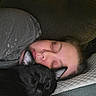 Loki is registered to the contest to win money with this photo: person, cat, black_cat, sleeping, couch, pillow, cozy, indoor, rest, nap, closeup, face, fur, relaxation, companion, pet, quiet, comfort, casual_clothing, home