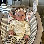 Olivia is registered to the contest to win money with this photo: baby, infant, headband, striped_clothing, baby_seat, toy, star_shaped_toy, cloud_shaped_toy, blanket, indoors, cute, child, person, striped_leggings, soft_toys, relaxing, portrait, wide_eyes, floral_pattern, hand