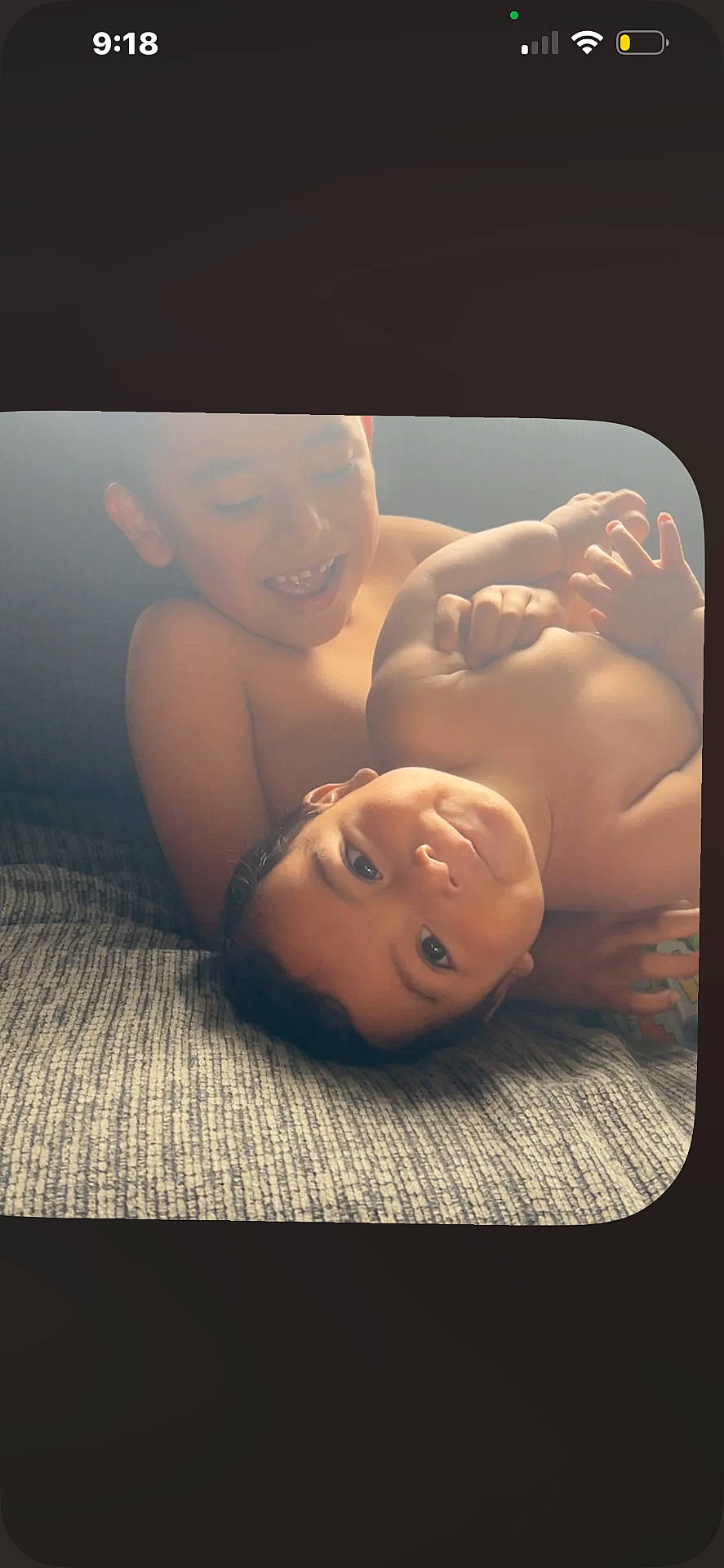 Brahim is registered to the contest to win money with this photo: baby, brother, candid, child, children, couch, face, family, happy, head, indoor, playful, portrait, shirtless, sibling, smiling, texture, toddler, two_people, young