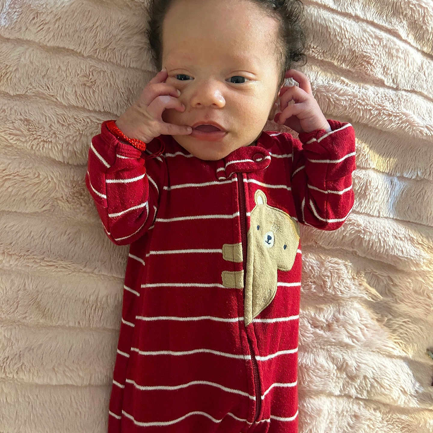 Kazire is registered to the contest to win money with this photo: baby, bear_patch, blanket, child, comfortable, curious_expression, cute, fluffy, hands_near_face, indoors, infant, lying_down, onesie, portrait, red_clothing, sleepwear, soft_texture, striped, warm, young