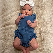 Brynleigh is registered to the contest to win money with this photo: baby, infant, child, headband, bow, romper, blue_clothing, blanket, soft_texture, lying_down, cute, small_hands, bare_feet, skin, face, eyes, indoor, portrait, adorable, curious