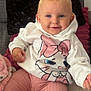 baby, child, smiling, hoodie, cartoon, cat, pink_pants, blue_eyes, couch, pillow, blanket, indoors, cute, happy, portrait, sitting, soft_texture, cozy, clothing, person
