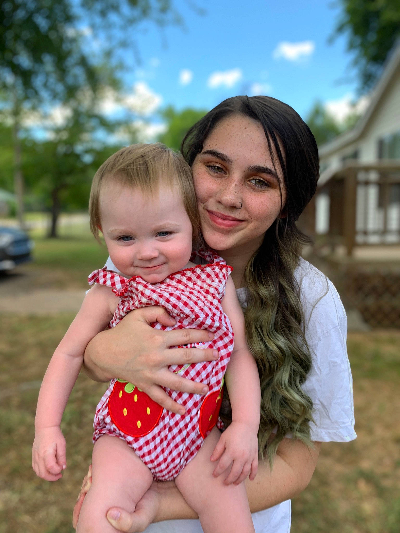 Ariella is registered to the contest to win money with this photo: arm, baby, cloud, face, finger, fun, grass, happy, iris, joy, leisure, people, people_in_nature, person, plant, shoulder, skin, sky, smile, summer