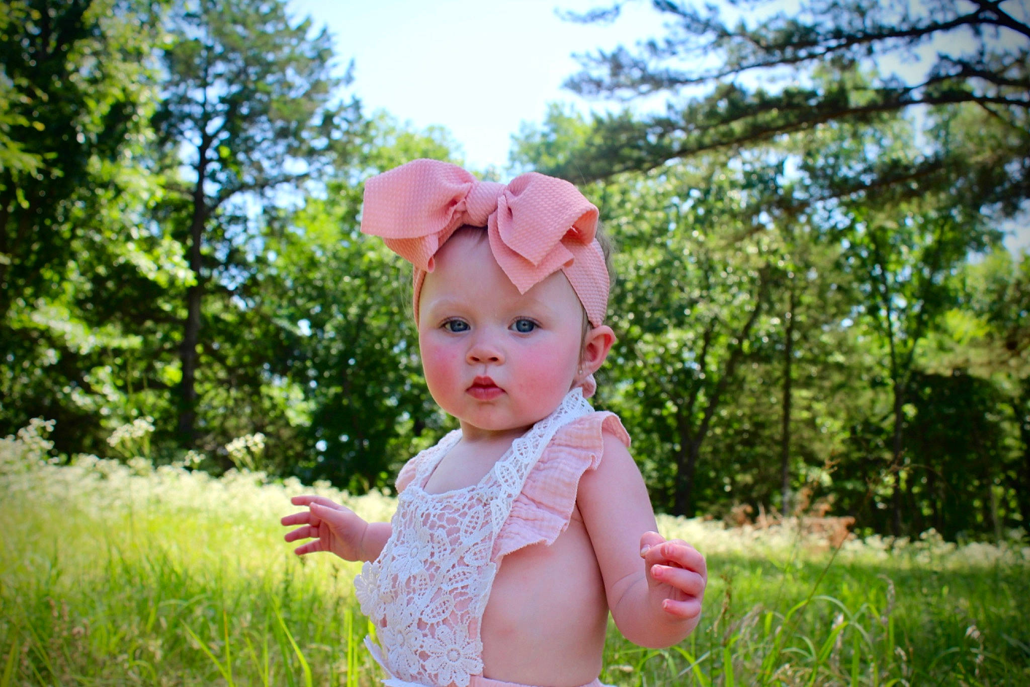 Ariella joined the competition — help win amazing prizes! baby, baby_toddler_clothing, cap, flower, grass, grassland, happy, hat, headwear, leaf, magenta, meadow, people_in_nature, person, plant, prairie, recreation, sky, sun_hat, sunlight
