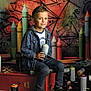 Nino a rejoint le concours — aidez-le/la à gagner de superbes lots ! artistic, background, boy, casual_clothing, child, colorful, crayons, creative, floor, graffiti, indoor, paint, portrait, shoes, sitting, smiling, spray_can, toy, urban_art, young
