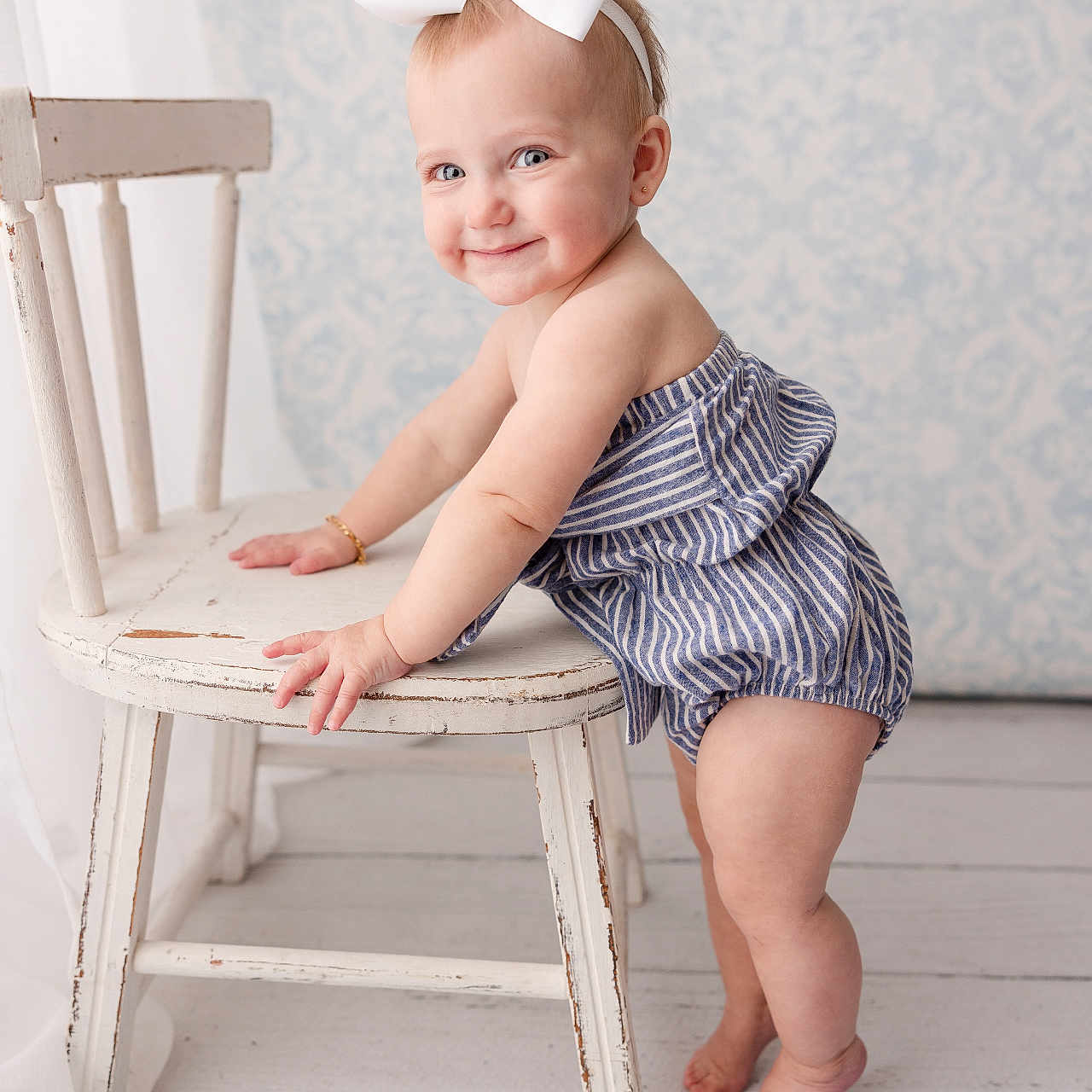 Quincy is registered to the contest to win money with this photo: baby, bodypart, chair, clothing, dress, face, finger, formalwear, furniture, hand, happy, hardwood, head, pants, person, photography, portrait, sitting, smile, wood