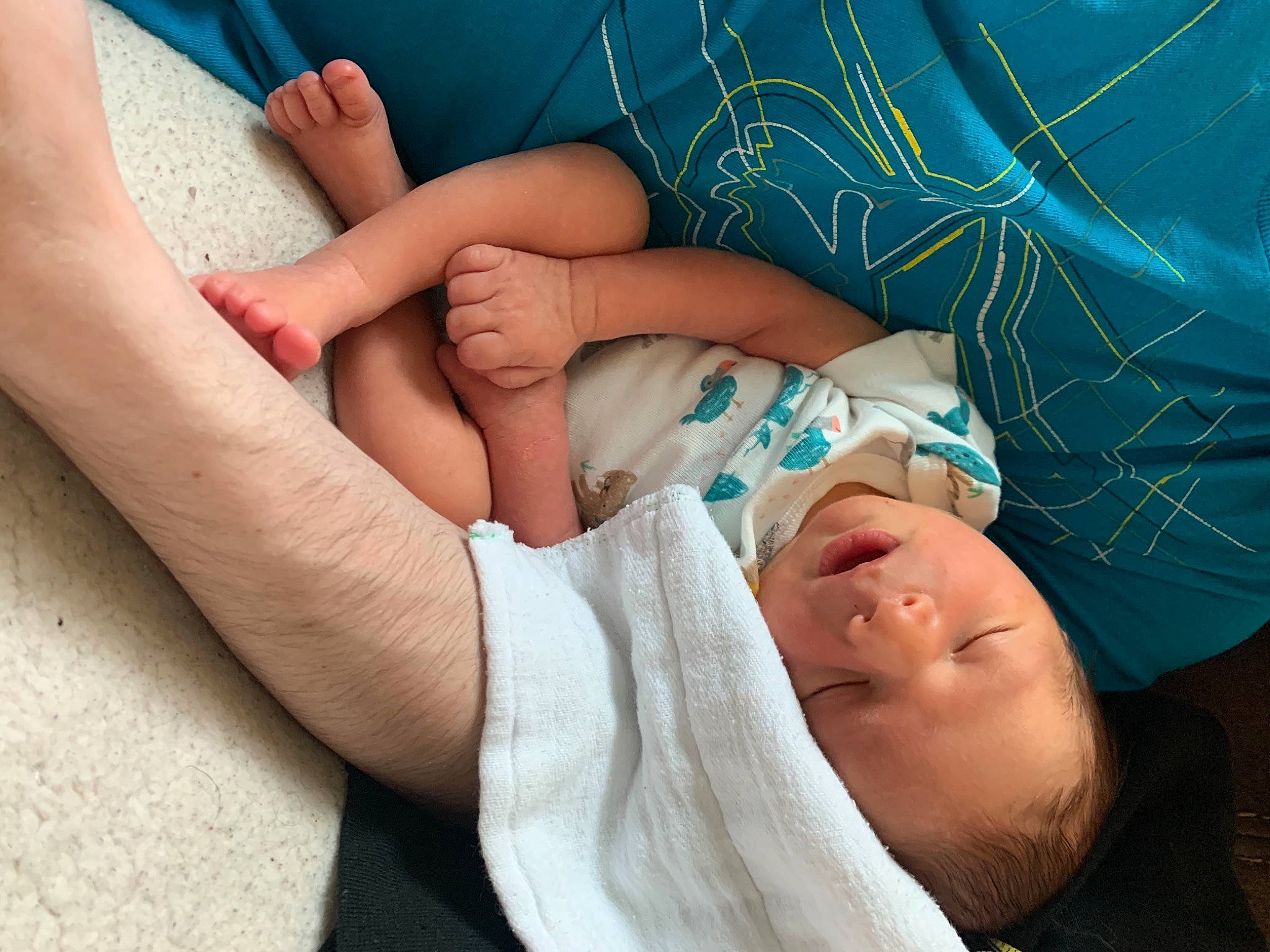 Tyrion is registered to the contest to win money with this photo: abdomen, arm, baby, blue, comfort, elbow, finger, gesture, hand, human_leg, joint, knee, leg, mouth, muscle, nail, person, skin, thigh, thumb