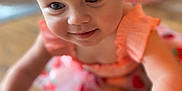 Bonnie joined the competition — help win amazing prizes! baby, child, girl, headband, pink, dress, floral, crawling, floor, wooden_floor, closeup, face, smile, curious, indoors, blurred_background, skin, arm, person, cute