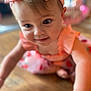 baby, child, girl, headband, pink, dress, floral, crawling, floor, wooden_floor, closeup, face, smile, curious, indoors, blurred_background, skin, arm, person, cute