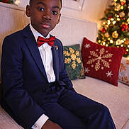 James-lebrown participe au concours pour gagner de l'argent avec cette photo : bow_tie, boy, celebration, child, christmas_tree, couch, festive, formal_wear, holiday, holiday_decorations, home, indoors, lights, pillow, portrait, seasonal, smiling, suit, window, young