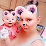 woman, baby, selfie, pink_bear_ears, pink_bear_nose, filter, sparkles, kitchen, cabinet, smile, holding, tank_top, hair_bun, cute, happy, portrait, indoor, person, child, face